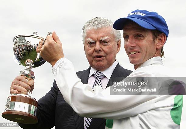 Trainer Bart Cummings and Jockey Peter Mertens hold up the trophy after their mount Sirmione won Race 8 the Darley Australian Cup during the...