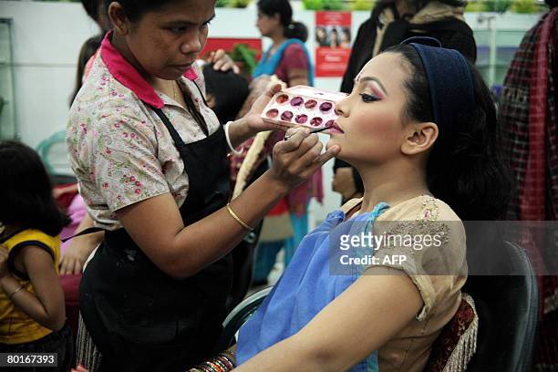 Young Bangladeshi bride has makeup applied at a beauty salon in Dhaka, on March 8 on the occasion of the International Womens' Day. Arranged...