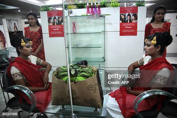 Bangladeshi bride waits patiently at a beauty salon, hours before her wedding which has been arranged for her by her family, in Dhaka, on March 8 on...