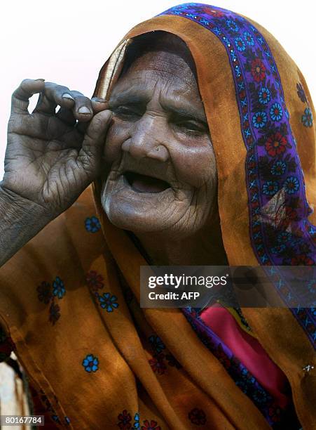 Eighty year old Indian woman Vahaliben Ramsingbhai Bhimani gestures as she speaks at her home in the Little Rann of Kutch in the Kharaghoda Salt...