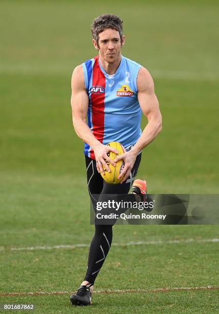 Robert Murphy of the Bulldogs kicks during a Western Bulldogs AFL training session at Whitten Oval on June 27, 2017 in Melbourne, Australia.