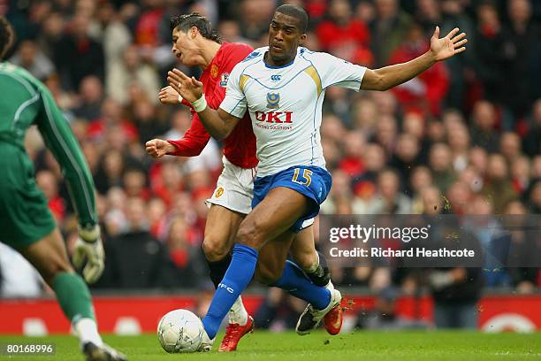 Cristiano Ronaldo of Manchester United is pushed off the ball by Sylvain Distin of Portsmouth during the FA Cup Sponsored by e.on Quarter Final match...