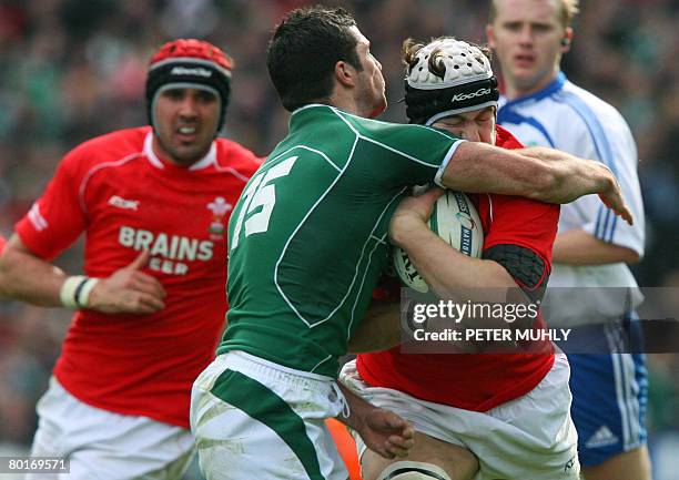 Wales Prop Adam Jones is tackled by Ireland's Robert kearney during the Six Nations rugby union international match at Croke Park, Dublin, on March...