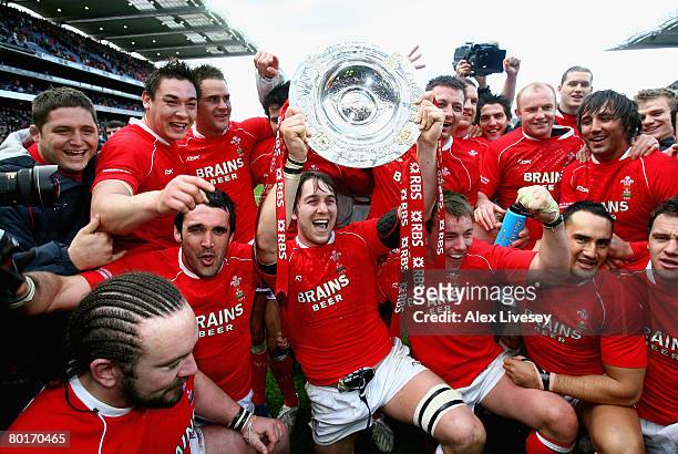 The Wales players celebrate with the Triple Crown following their team's victory at the end of the RBS 6 Nations Championship match between Ireland...