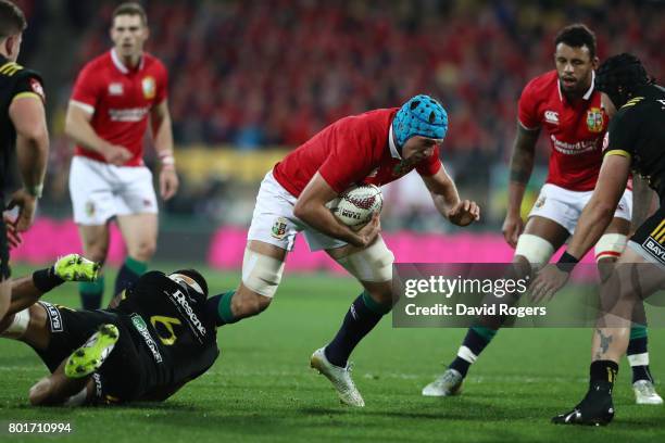 Justin Tipuric of the Lions is tackled by Vaea Fifita of the Hurricanes during the 2017 British & Irish Lions tour match between the Hurricanes and...