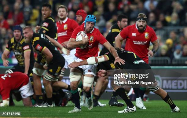 Justin Tipuric of the Lions is tackled by Callum Gibbins of the Hurricanes during the 2017 British & Irish Lions tour match between the Hurricanes...