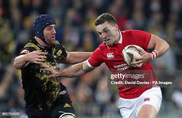 British and Irish Lions' George North is tackled by Hurricanes' Mark Abbott during the tour match at the Westpac Stadium, Wellington.