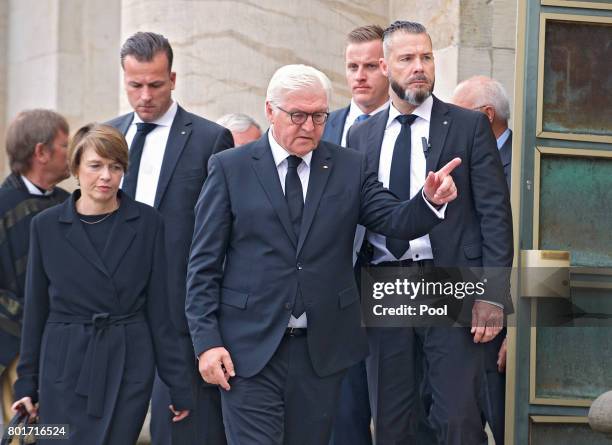 German President Frank-Walter Steinmeier and wife Elke Buedenbender leave after attending a memorial service at the St. Hedwig Cathedral for former...