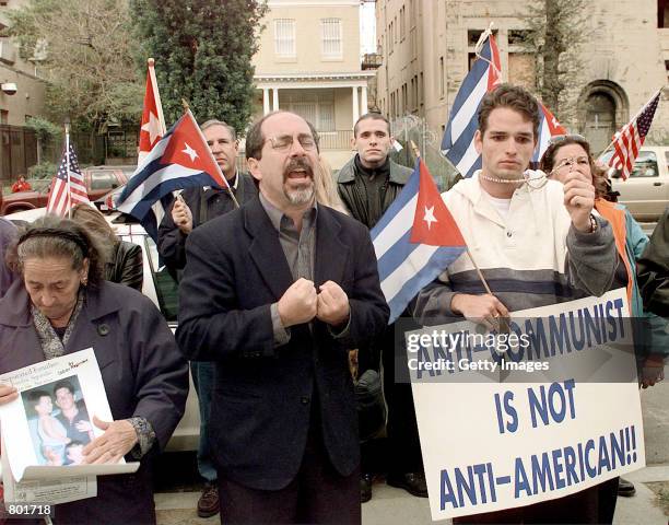 Rev. Patrick Mahoney leads the group called "New Generation" in prayer April 27, 2000 outside the Cuban Interests Section in Washington, DC. A...