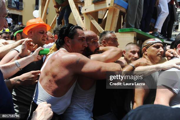 Men carry a 25-metre tall wood and papier-mache statue called 'giglio' during the annual Festa dei Gigli on June 25, 2017 in Nola, Italy. When St....