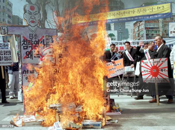 South Korean protesters set fire to boxes meant to represent Japanese goods during an anti-Japan protest rally April 14, 2001 in Seoul. About 200...