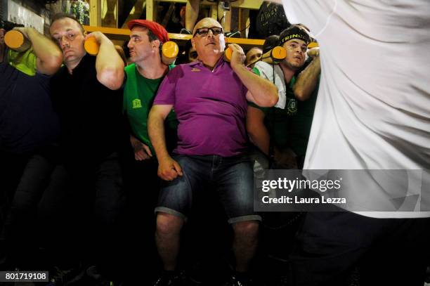 Men carry a 25-metre tall wood and papier-mache statue called 'giglio' during the annual Festa dei Gigli on June 26, 2017 in Nola, Italy. When St....