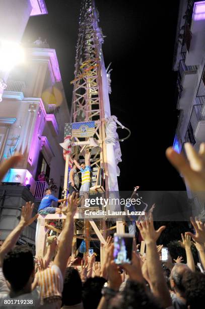 Men carry a 25-metre tall wood and papier-mache statue called 'giglio' during the annual Festa dei Gigli on June 25, 2017 in Nola, Italy. When St....