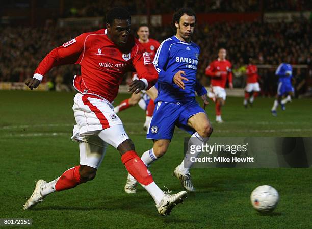 Kayode Odejayi of Barnsley crosses the ball ahead of Ricardo Carvalho of Chelsea during the FA Cup sponsored by E.ON 6th Round match between Barnsley...