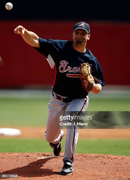 Pitcher Buddy Carlyle of the Atlanta Braves makes a pitch against the Cincinnati Reds during the Grapefruit League Spring Training game on March 8,...