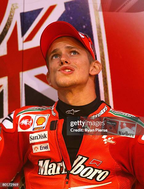 Casey Stoner of Australia and the Ducati Marlboro Team looks on from the pits before qualifying for the Motorcycle Grand Prix of Qatar, round one of...