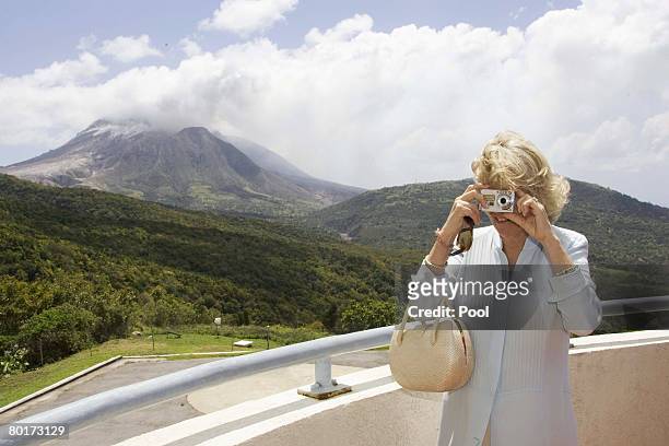 Soufrie Volcano looms in the background covered in smoke and steam as Camilla, Duchess of Cornwall visit the Volcano Observatory tour the exclusion...