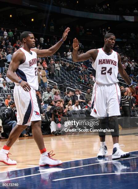 Joe Johnson and Marvin Williams of the Atlanta Hawks celebrate the overtime win against the Miami Heat at Philips Arena March 8, 2008 in Atlanta,...