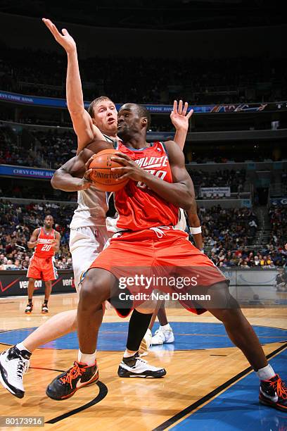 Emeka Okafor of the Charlotte Bobcats holds ball against Darius Songaila of the Washington Wizards at the Verizon Center on March 8, 2008 in...