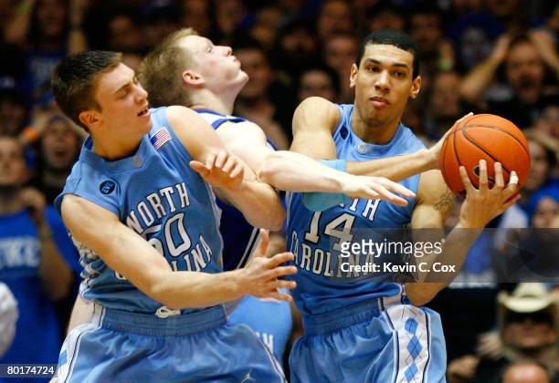 Danny Green of the North Carolina Tar Heels grabs a rebound against Tyler Hansbrough and Kyle Singler of the Duke Blue Devils during the second half...