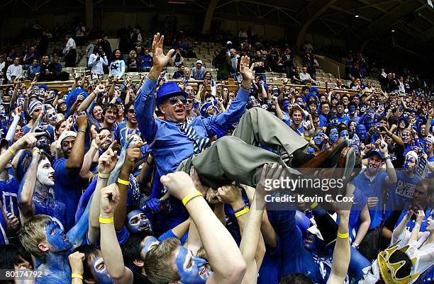 Sports commentator Dick Vitale surfs the Cameron Crazies before the game between the Duke Blue Devils and the North Carolina Tar Heels at Cameron...