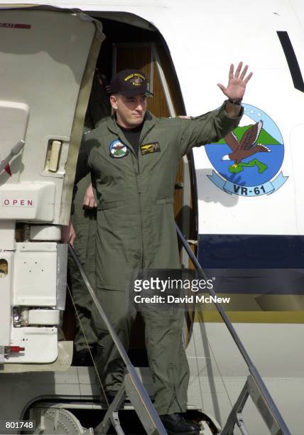 Navy Lt. Shane Osborn, of Norfolk, NE, waves to the welcoming crowd as the crew of the U.S. Navy EP-3 surveillance plane arrive at Whidbey Island...