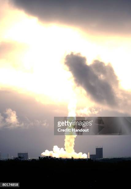 In this handout image provided bt the European Space Agency, Ariane 5 and Europe's Jules Verne automated transfer vehicle lifts off from the European...