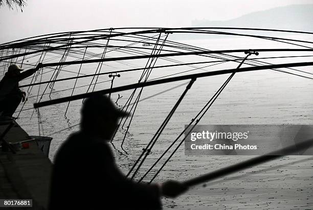 People fish at the East Lake on March 9, 2008 in Wuhan of Hubei Province, China. East Lake, the largest lake within a city in China, is located on...