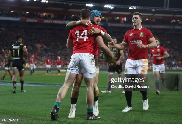 Tommy Seymour of the Lions is congratulated by teammates Jack Nowell and George North of the Lions after scoring his team's third try during the 2017...