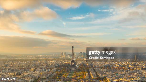 cityscape of the eiffel tower and the city of paris, france with golden sunset light in the sky and the new skyscrapers in the distance - montparnasse stock pictures, royalty-free photos & images