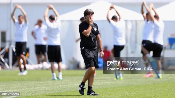 Head coach Joachim Loew walks past players during a Germany training session at Sotchi Parc Arena ahead of their FIFA Confederations Cup Russia 2017...