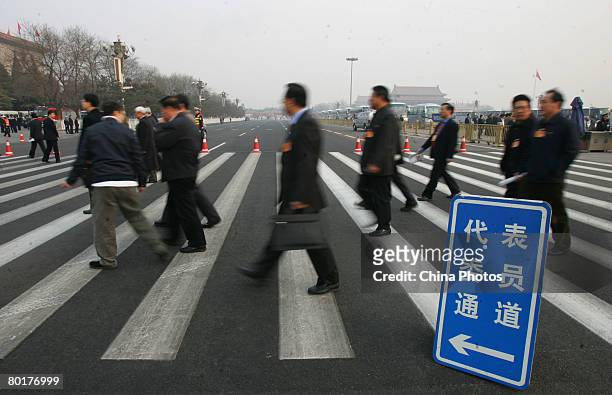 Delegates arrive at the Great Hall of the People to attend the third plenary meeting of the CPPCC on March 9, 2008 in Beijing, China. The CPPCC is...