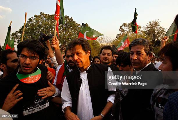 Imran Khan , former cricketer turned political leader of Pakistan's Tehreek-e-Insaf , walks with protestors to the home of the deposed Chief Justice,...