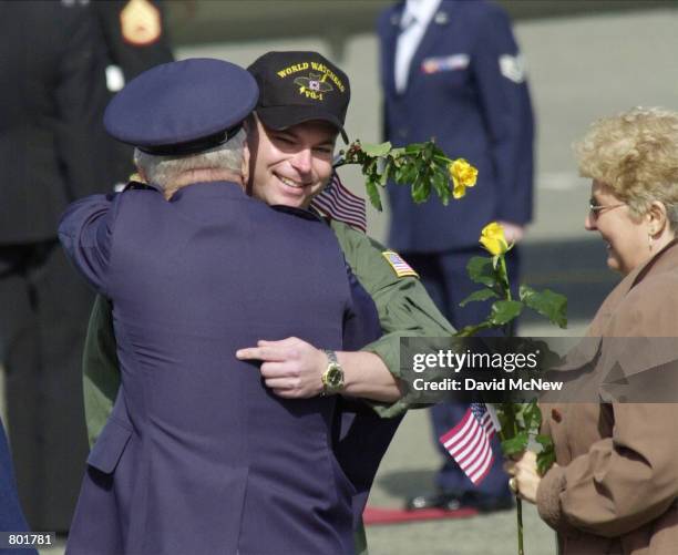 Sailor Jeremy Crandall from Poplar Grove, IL hugs a family member as the crew of the U.S. Navy EP-3 surveillance plane arrive at Whidbey Island Naval...