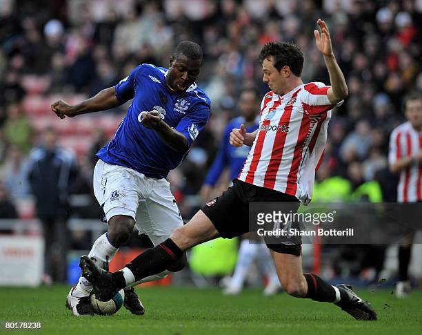 Yakubu of Everton holds is tackled by Jonny Evans of Sunderland during Barclays Premier League match between Sunderland and Everton at the Stadium of...