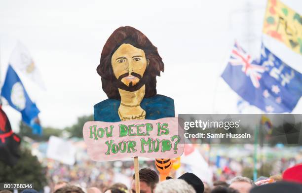 Festival goers hold up a sign as they watch Barry Gibb perform on day 4 of the Glastonbury Festival 2017 at Worthy Farm, Pilton on June 25, 2017 in...