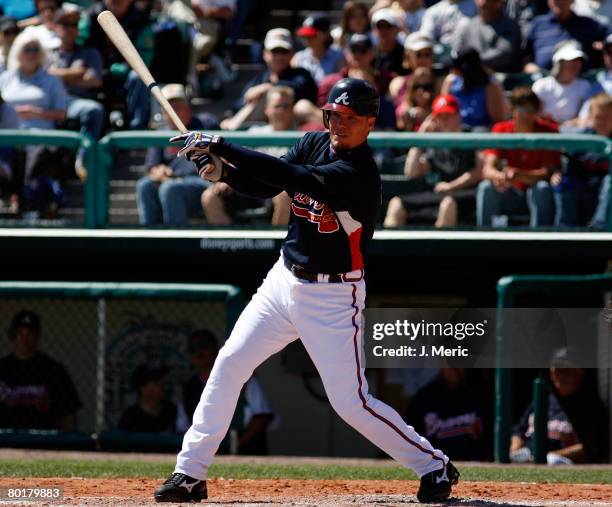 Infielder Chipper Jones of the Atlanta Braves fouls off a pitch against the St. Louis Cardinals during the Grapefruit League Spring Training game on...