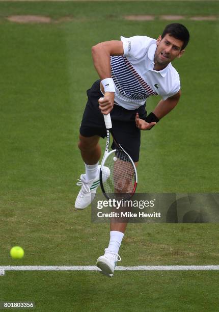 Novak Djokovic of Serbia serves to Vasek Pospisil of Canada during Day 3 of the Aegon International Eastbourne tournament at Devonshire Park on June...