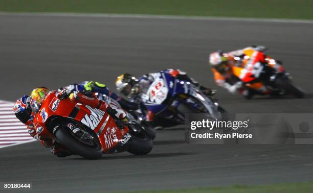 Casey Stoner of Australia and the Ducati Marlboro Team leads during the Motorcycle Grand Prix of Qatar, round one of the MotoGP World Championship at...