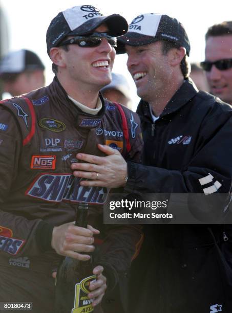 Kyle Busch, driver of the Snickers Toyota, celebrates with car owner J.D. Gibbs, in victory lane after winning the NASCAR Sprint Cup Series Kobalt...