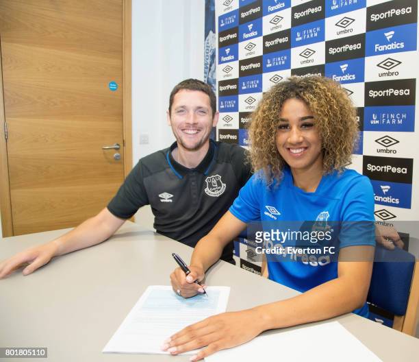 Gabby George of Everton Ladies poses for a photo with Everton Ladies manager Andy Spence after signing a full-time contract with Everton Ladies at...