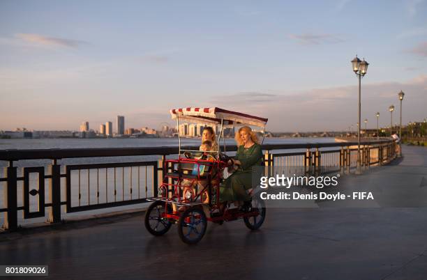 People ride a quadricycle on a promenade by the Volga river during the Confederations Cup on June 26, 2017 in Kazan, Russia.
