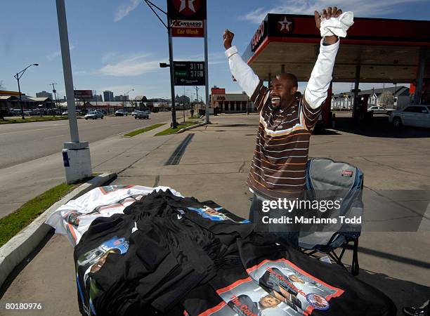 Supporter of Democratic presidential hopeful Sen. Barack Obama Moe Mac of Dallas, Texas waves at a passersby on High Street as he sells T-shirts...