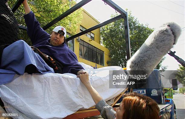 Manuel Uribe , the world's fattest man according to the Guinness Book of Records, is greeted while leaving for a drive atop a truck on March 9, 2008...