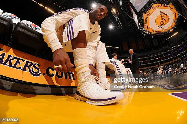 Kobe Bryant of the Los Angeles Lakers ties his shoe prior to the game against the Sacramento Kings at Staples Center on March 9, 2008 in Los Angeles,...