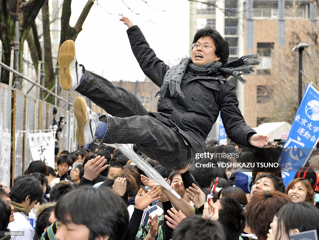 A student is tossed into the air to cele