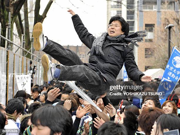 Student is tossed into the air to celebrate his successful entrance exam results at Tokyo University in Tokyo on March 10, 2008. Tokyo University,...