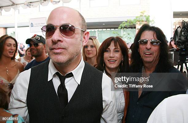 John Varvatos watches with Alice Cooper and wife Sheryl the band Cheap Trick perform at The John Varvatos 6th Annual Stuart House Benefit at the John...