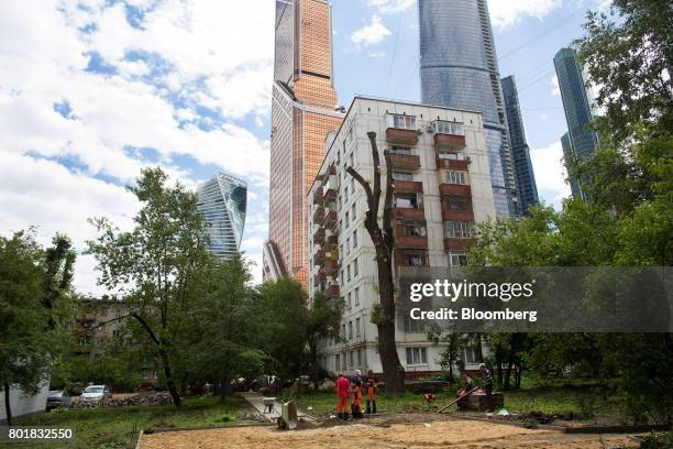 Soviet era apartment block, also known as a "khruschchoby," due for demolition, center, stands in the shadow of the Moscow International Business...