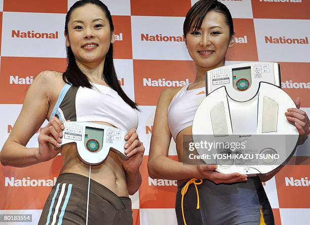 Models displays Japanese electronics giant Matsushita Electric Industrial's body composition monitor "EW-FA70" equipped with the newly developed...